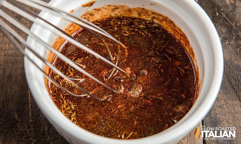 whisking rub ingredients in ramekin for air fryer whole chicken