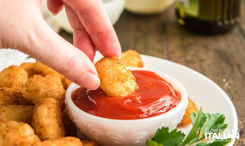 dipping air fried tater tot in ketchup