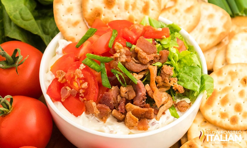 blt dip surrounded with crackers, tomatoes, and lettuce