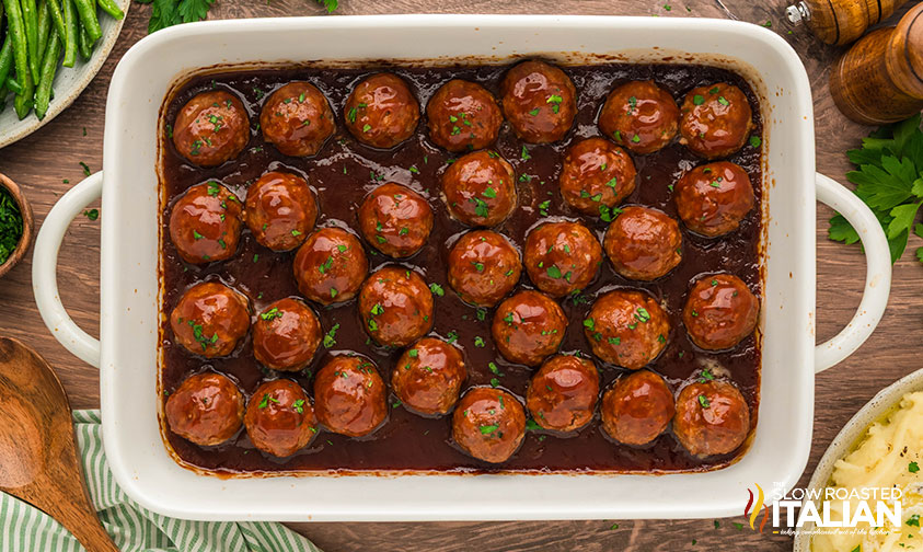 baked meatloaf meatballs covered in sauce in a large baking dish