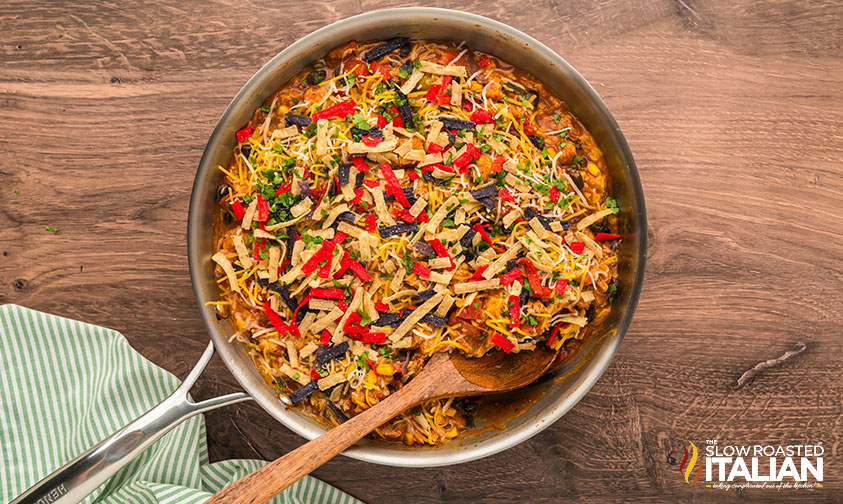 tortilla strips sprinkled over chicken enchilada skillet