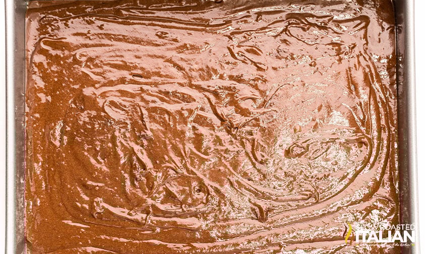 chocolate dr pepper cake batter poured into a baking pan