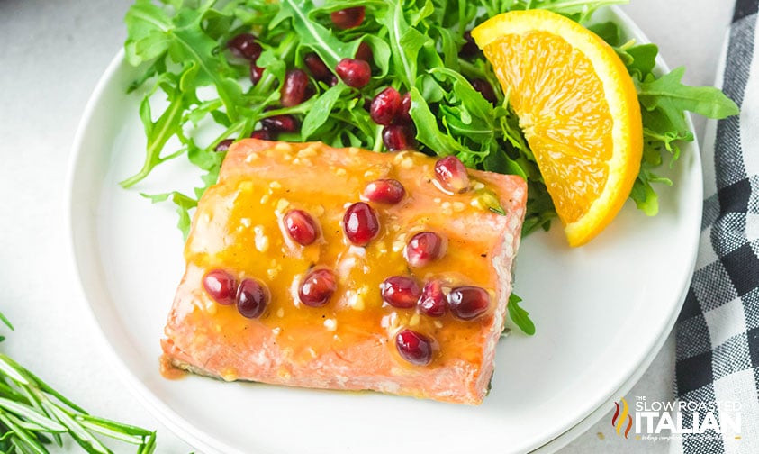 orange glazed salmon on a white plate