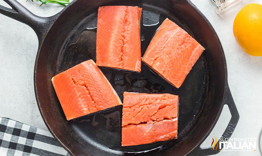 seasoned salmon in a cast iron skillet