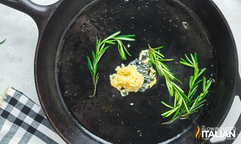 garlic and rosemary in cast iron skillet
