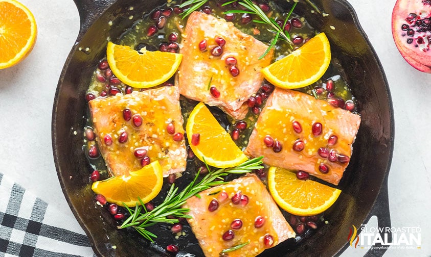 orange glazed salmon in a cast iron skillet