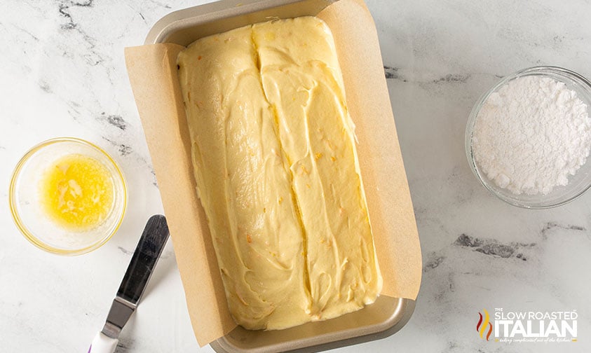 orange pound cake batter in a loaf pan