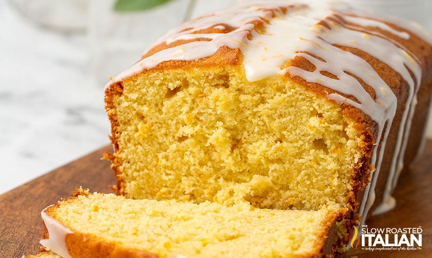 sliced orange pound cake with drizzled glaze on top