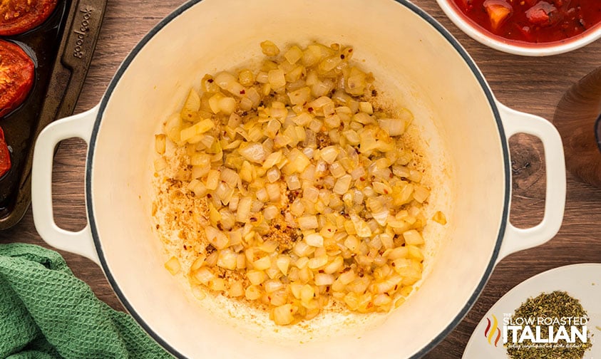 cooking onions, garlic, and crushed red pepper for roasted tomato soup