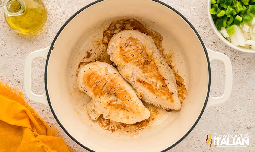 seared chicken in a large dutch oven