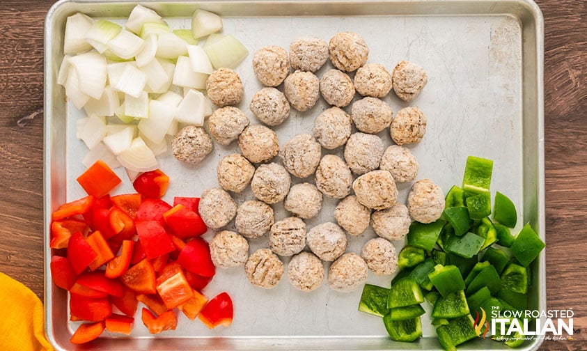 adding ingredients for sweet and sour meatballs to a sheet pan