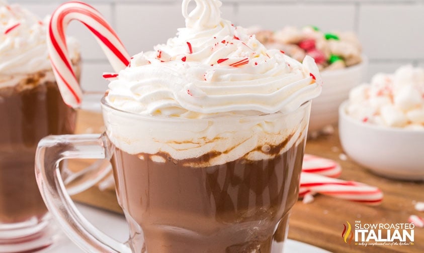 peppermint mocha with whipped cream and candy cane in a clear mug