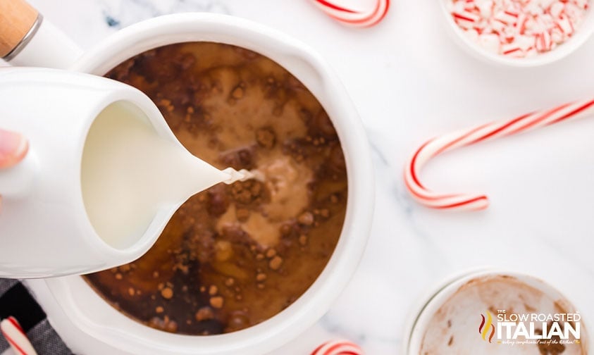 pouring milk into saucepan with cocoa and coffee