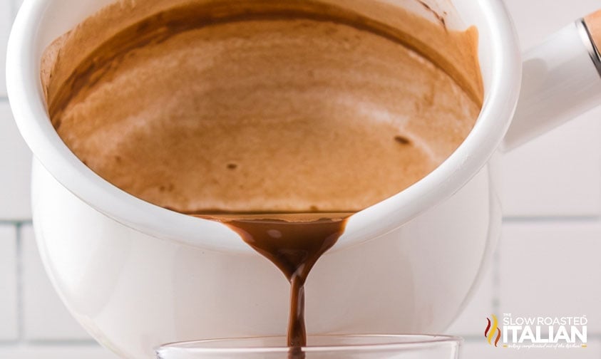 pouring homemade peppermint mocha into mug