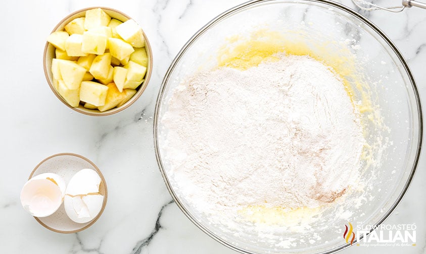 adding flour and apples to batter for irish apple cake