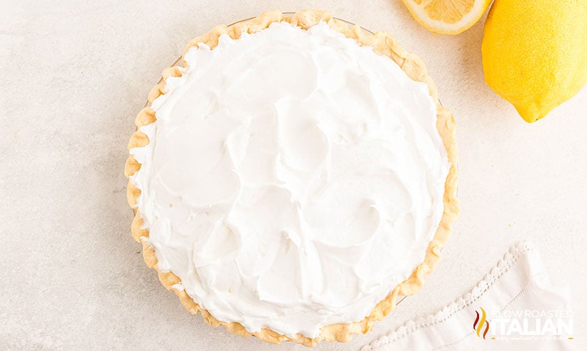adding meringue topping to lemon meringue pie