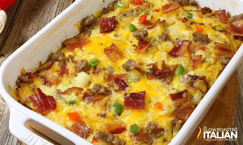 baked breakfast casserole with bacon, sausage, and potatoes with peppers and onions