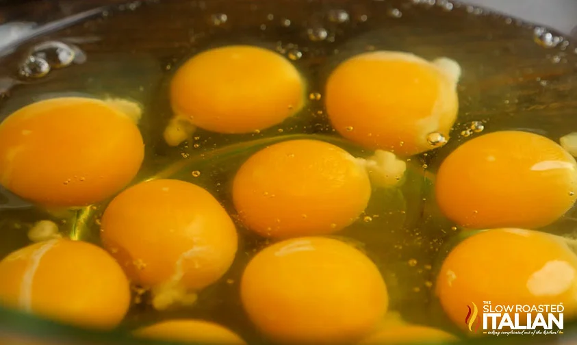 closeup: cracked eggs in large bowl