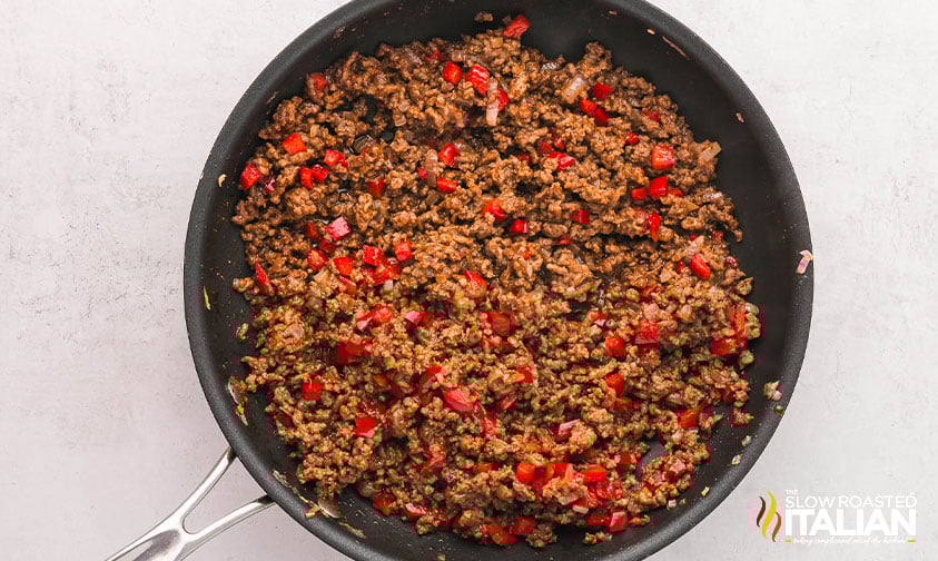 cooking ground beef for taco bowls in a skillet