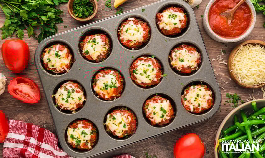 baked meatloaf cups topped with shredded mozzarella and garnished with parsley