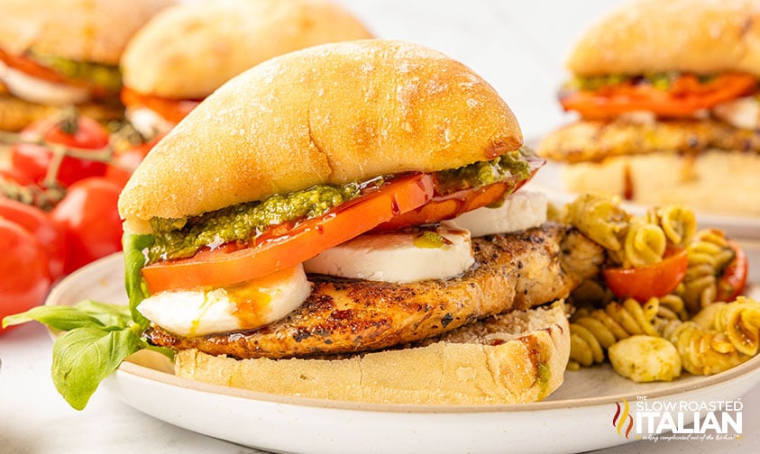 chicken caprese sandwich on a plate with pasta salad