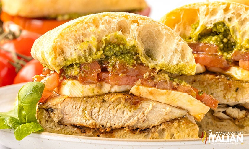 closeup of a sliced chicken caprese sandwich
