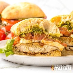 Closeup of a sliced chicken caprese sandwich on a plate