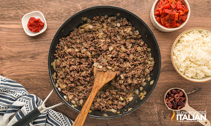 cooking ground beef and onions for stuffed greek peppers
