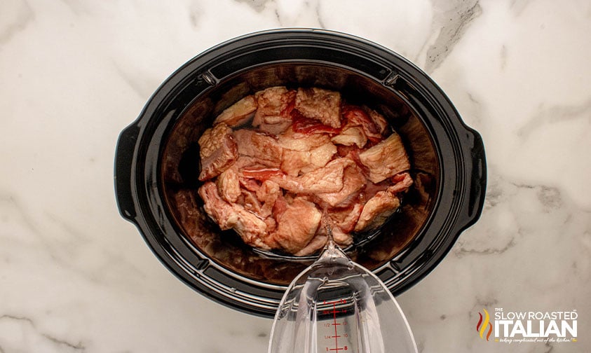 beef fat and water added to slow cooker to render beef tallow