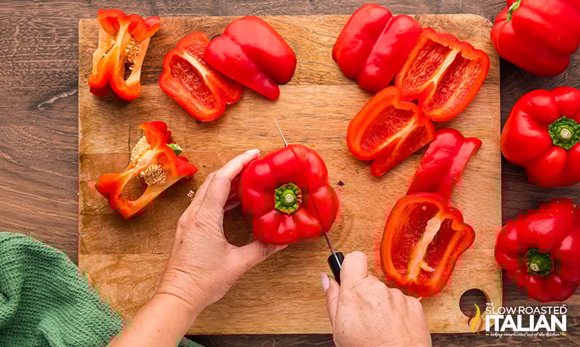 prepping roasted red peppers on a cutting board