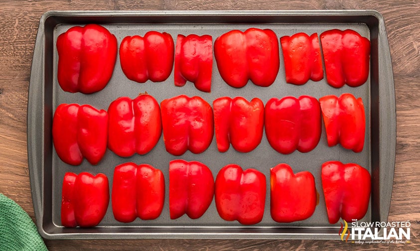 roasted red peppers skin side up on a baking sheet