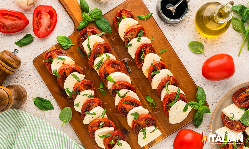 layered caprese salad recipe on a wooden cutting board
