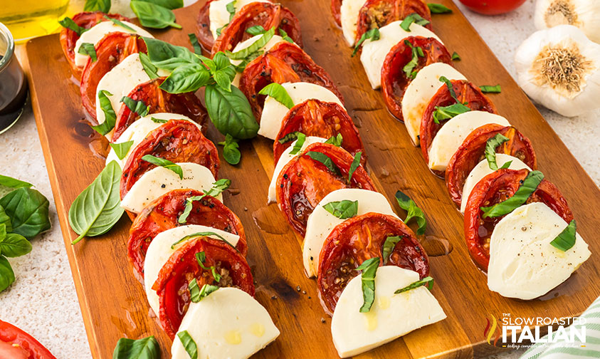 closeup of caprese salad recipe on a wooden board