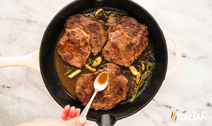 basting boneless steak recipe in a cast iron skillet