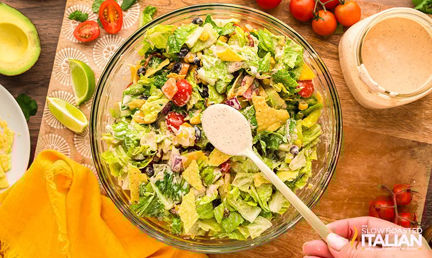 spooning dressing over southwest chopped salad