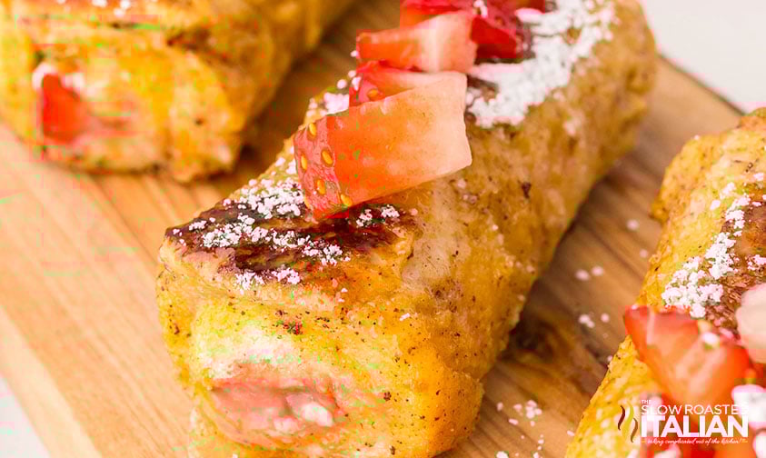 closeup of french toast rollups on a wooden board