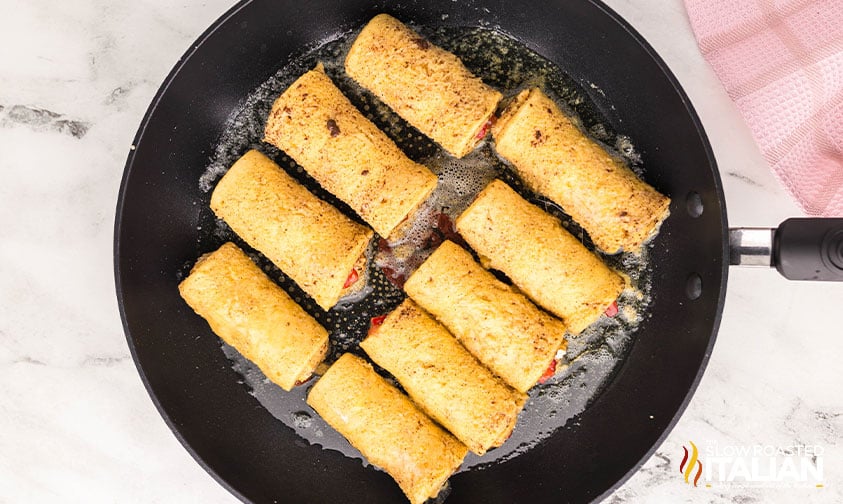 cooking french toast rollups in a hot skillet