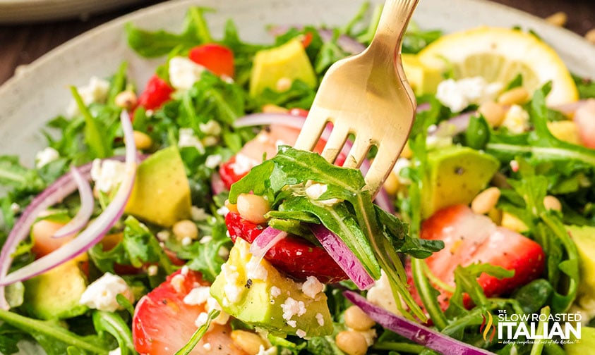 closeup of arugula salad recipe on a fork