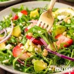 closeup of a fork full of arugula salad recipe