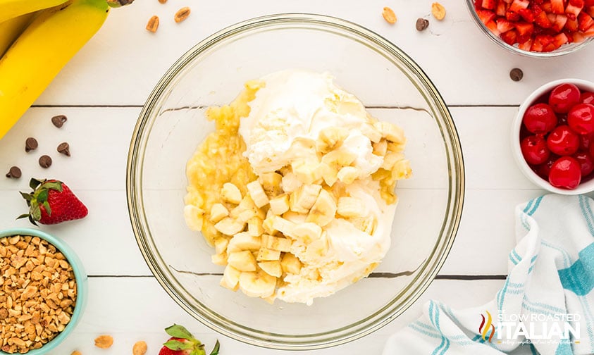 mashing bananas and ice cream for banana split popsicles