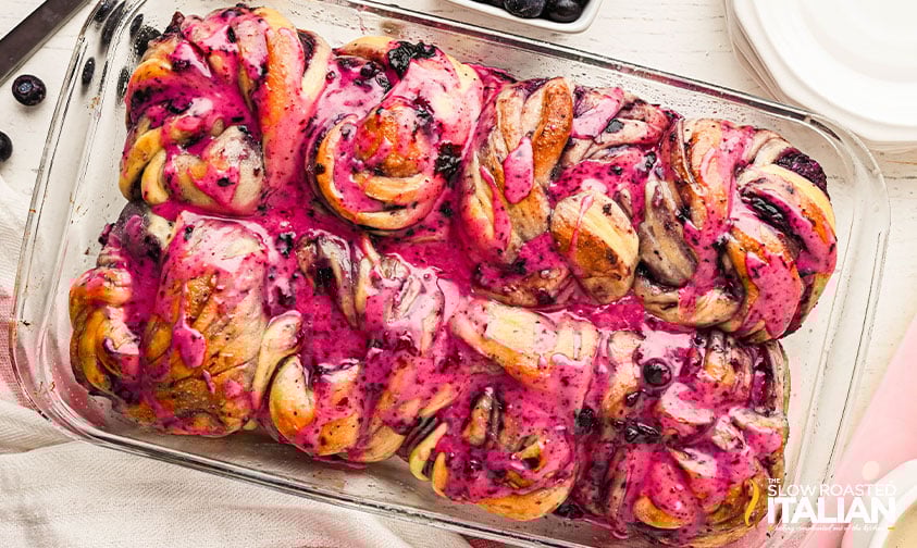 drizzled icing over blueberry sweet rolls