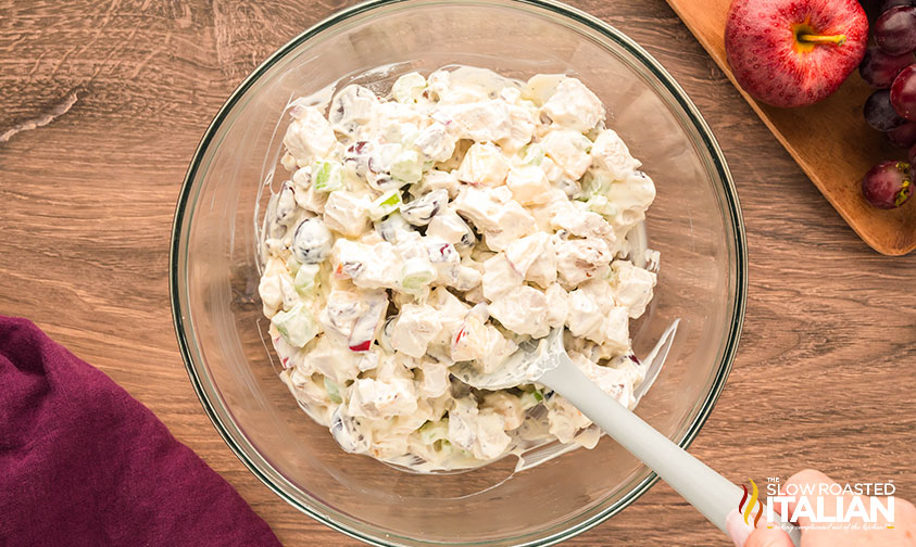 mixed chicken salad with grapes and apples in a large glass bowl