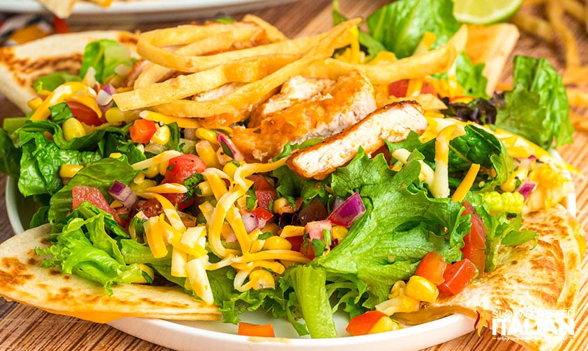 quesadilla explosion salad with crispy chicken, cheese, and creamy dressing