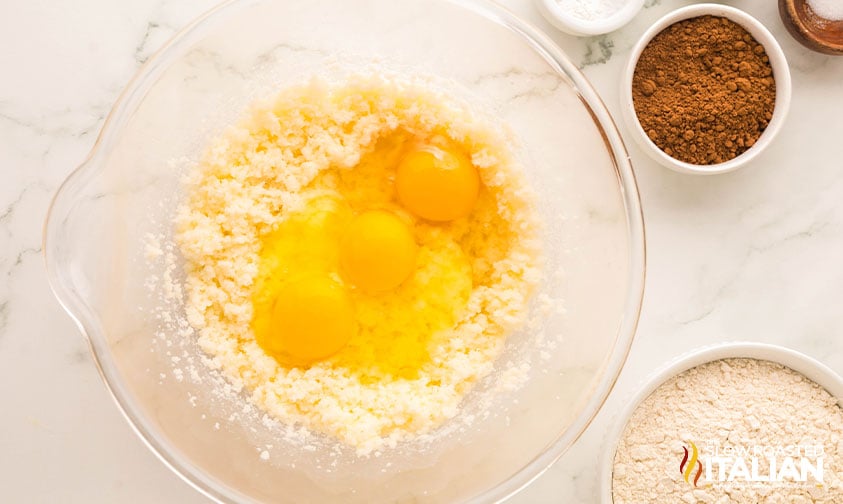 adding eggs to chocolate tres leches cake batter