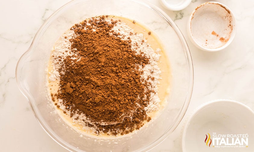 adding cocoa powder to chocolate tres leches cake batter