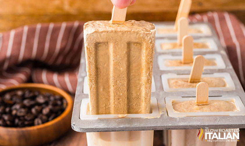 pulling frozen coffee popsicles out of popsicle mold