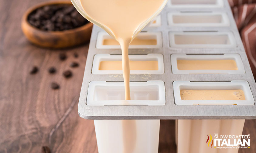 filling popsicle molds with coffee popsicles mixture