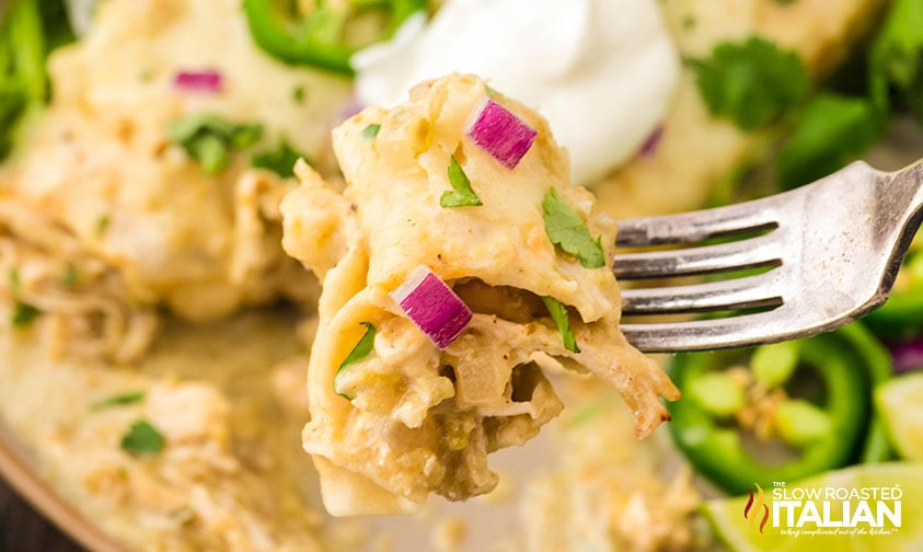 closeup of a bite of salsa verde chicken enchiladas