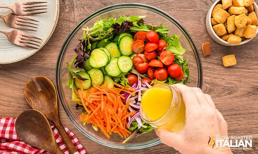 drizzling vinaigrette over mixed green salad