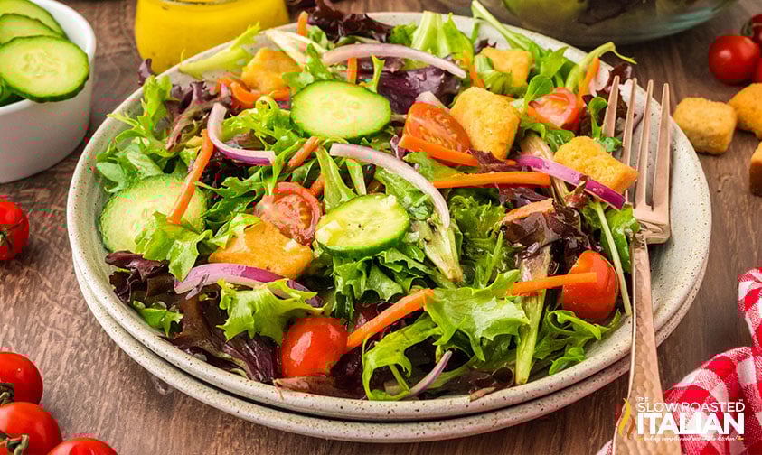 full plate of mixed green salad with croutons